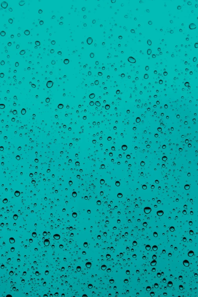 Water droplets on window glass, blue background, wallpaper